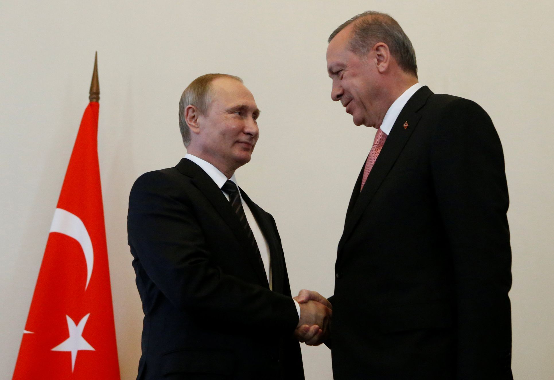 Russian President Putin shakes hands with Turkish President Erdogan during their meeting in St. Petersburg