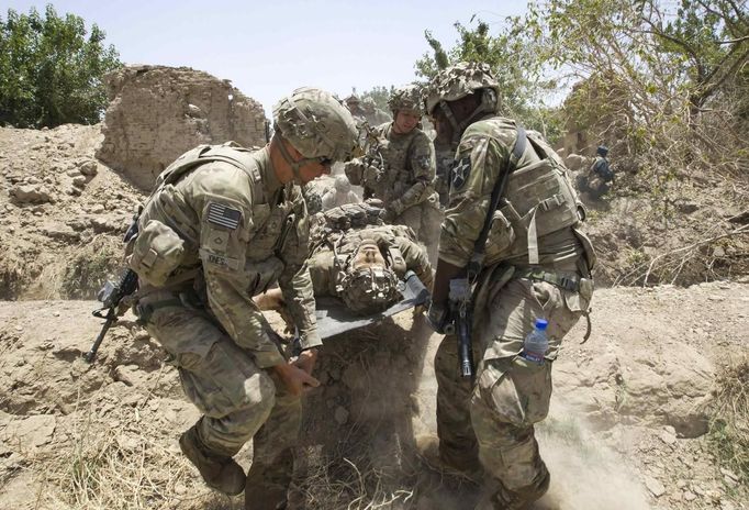 U.S. Army soldiers carry Sgt. Matt Krumwiede, who was wounded by an improvised explosive device (IED), towards a Blackhawk Medevac helicopter in southern Afghanistan June 12, 2012. On June 12, 2012, Krumwiede was on patrol in Afghanistan when he stepped on an IED, which tore away both his legs, damaged his left arm, and ripped open his abdominal cavity. The 22-year-old has since undergone around 40 surgeries and is learning to walk with prosthetic legs. He is keen to re-join the infantry as soon as his injuries allow. U.S. troops have been in Afghanistan since 2001. Thousands of Afghan elders gathered in Kabul on November 21, 2013 at a Loya Jirga, or grand council, to debate a crucial security pact with the United States, a day after Kabul and Washington reached a draft agreement laying out the terms under which U.S. troops may stay beyond 2014. Picture taken June 12, 2012.