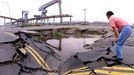 A man at Taichung Port, 170-km southwest of Taipei, looks at a quake-opened sinkhole, 25 September 1999, that is filled with molasses spilled from nearby storage tanks destroyed in the September 21 earthquake. Officials say it will take three to six months to put three wharves back into operation. (ELECTRONIC IMAGE)