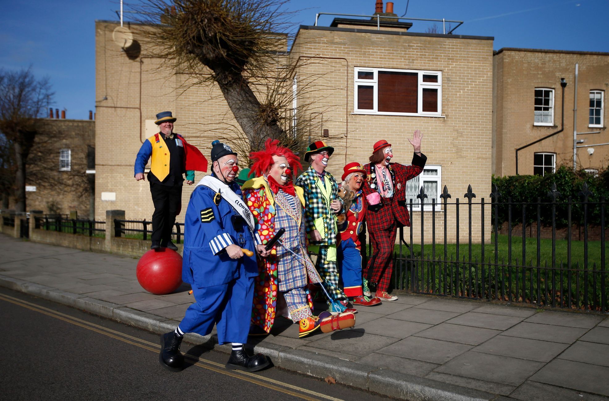 Clowns arrive at the All Saints Church before the Grimaldi clown service in Dalston, north London