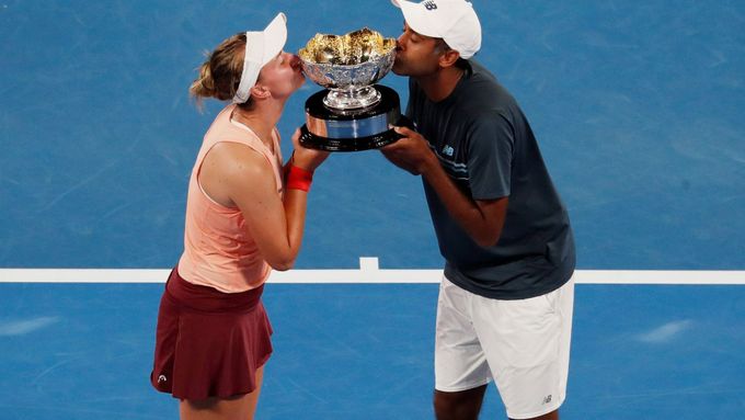Takhle líbala Barbora Krejčíková trofej pro vítěze smíšené čtyřhry na Australian Open před rokem s Rajeevem Ramem