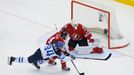 Finland's Olli Palola and Canada's Ryan Ellis chase the puck in front of Canada's goalie Ben Scrivens during the first period of their men's ice hockey World Championship