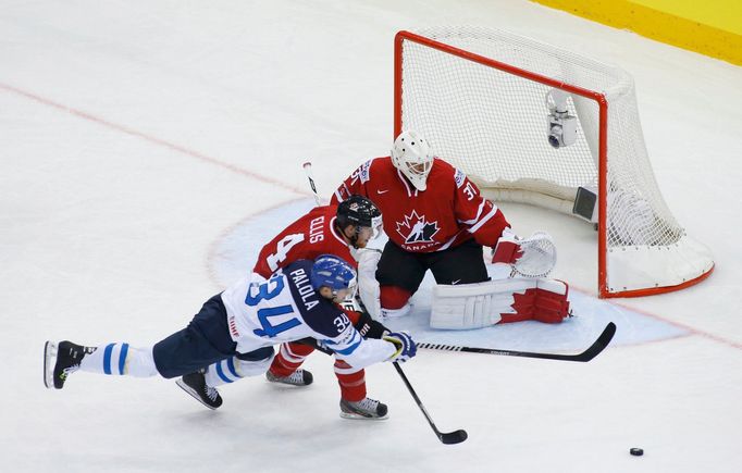 Finland's Olli Palola and Canada's Ryan Ellis chase the puck in front of Canada's goalie Ben Scrivens during the first period of their men's ice hockey World Championship