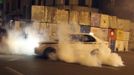 A taxi tries to find its way out as it gets caught in tear gas fired by police on protesters during clashes near the Presidential Palace in Cairo February 11, 2013. Protesters demanding the departure of Egyptian President Mohamed Mursi clashed with police outside his palace on Monday on the second anniversary of the overthrow of veteran autocrat Hosni Mubarak. Dozens of youths threw rocks at the Ettihadiya palace after a peaceful march by thousands of demonstrators who accused Mursi's conservative Muslim Brotherhood of hijacking Egypt's democratic revolution and seeking to monopolise power. REUTERS/Asmaa Waguih (EGYPT - Tags: POLITICS CIVIL UNREST) Published: Úno. 11, 2013, 8:47 odp.