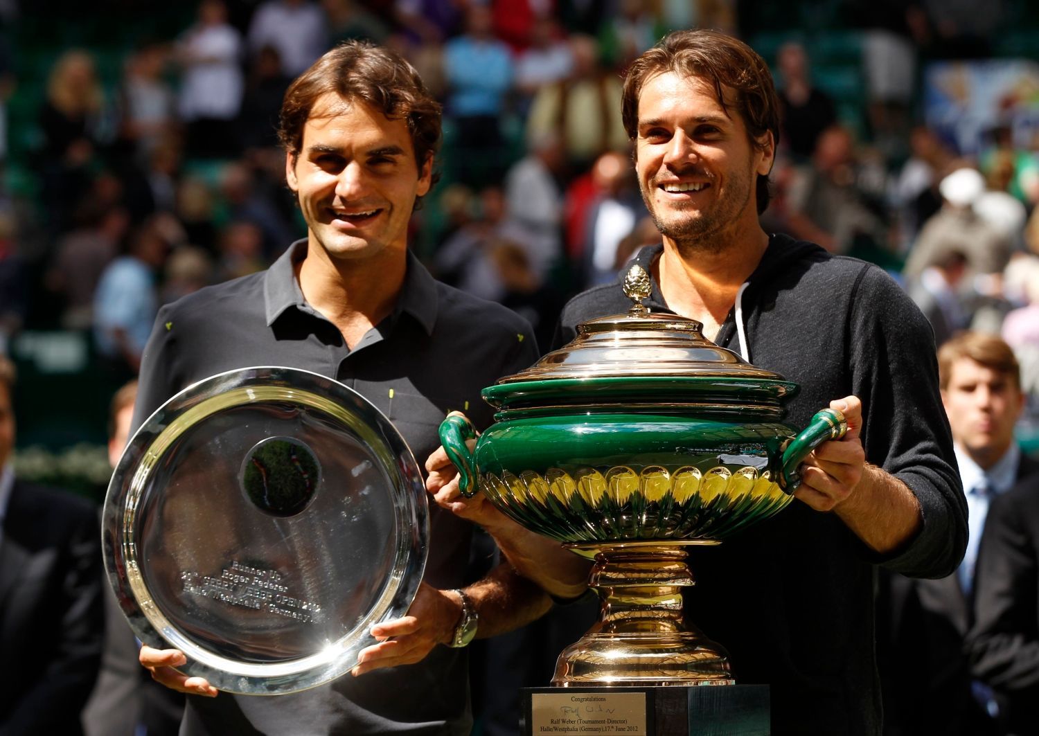 Německý tenista Tommy Haas po vítězství na turnaji ATP v německém Halle. Vedle něj finalista Švýcar Roger Federer.