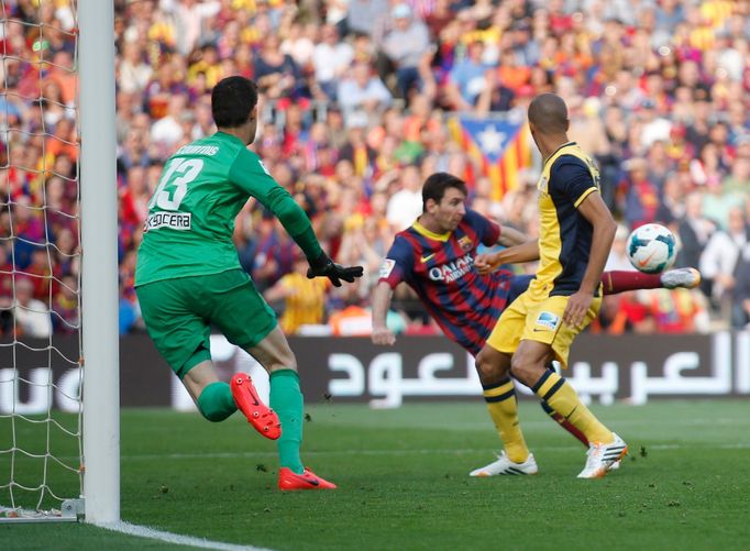 Atletico Madrid's goalkeeper Courtois watches as Barcelona's Messi kicks to score a goal that was later disallowed during their Spanish first division match in Barcelona