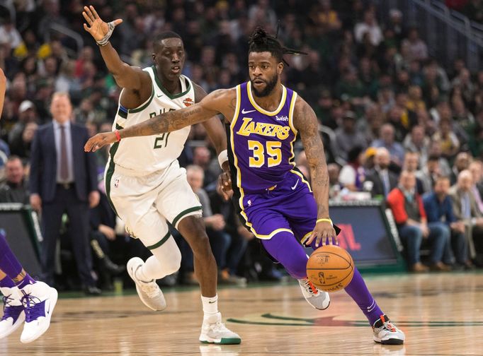 Mar 19, 2019; Milwaukee, WI, USA; Los Angeles Lakers guard Reggie Bullock (35) drives for the basket in front of Milwaukee Bucks guard Tony Snell (21) during the first qu