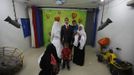 Palestinian groom Emad al-Malalha, 21, poses for a photograph with Manal Abu Shanar, 17, his Egyptian bride, and his relatives after the couple's arrival from a smuggling tunnel at a studio in Rafah in the southern Gaza Strip March 21, 2013. Al-Malaha , who said that his bride was not given a permit from Egyptian authorities to enter the Gaza Strip, brought her from neighboring Egypt through a smuggling tunnel to celebrate his wedding in his native Gaza Strip. REUTERS/Ibraheem Abu Mustafa (GAZA - Tags: POLITICS SOCIETY) Published: Bře. 21, 2013, 6:27 odp.