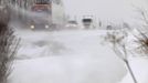 High winds blow snow as lorries make their way on road in Vicogne between Doullens and Amiens, northern France, March 11, 2013. Winter weather with snow and freezing temperatures returns to France. REUTERS/Pascal Rossignol (FRANCE - Tags: ENVIRONMENT) Published: Bře. 11, 2013, 4:03 odp.