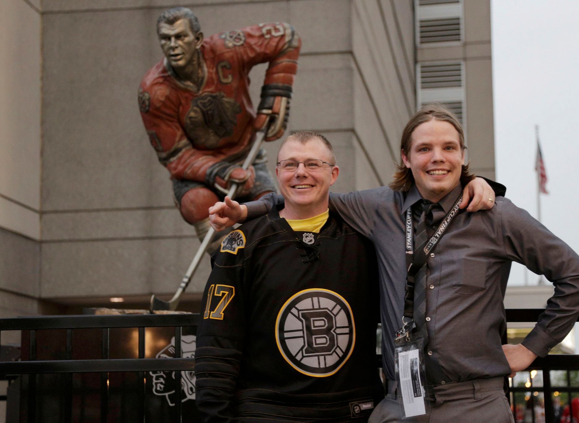 Boston Bruins fans pose outside of the venue as they arrive