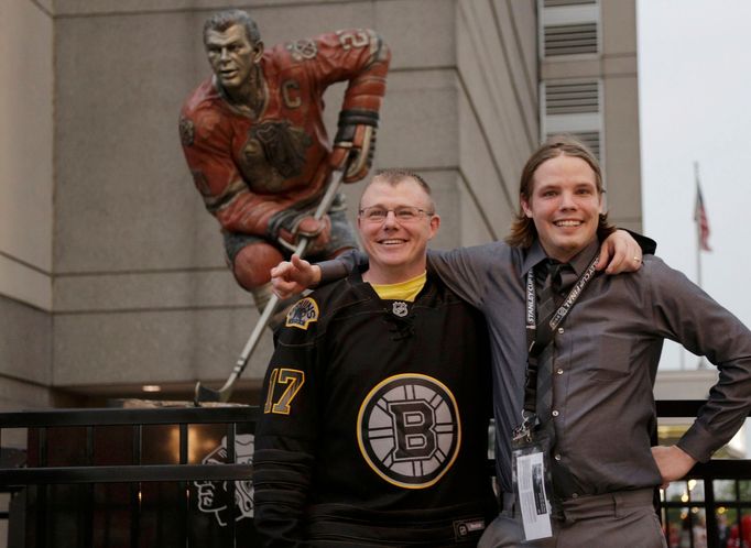 Boston Bruins fans pose outside of the venue as they arrive for Game 1 of the NHL Stanley Cup Finals hockey series against the Chicago Blackhawks in Chicago, Illinois, Ju