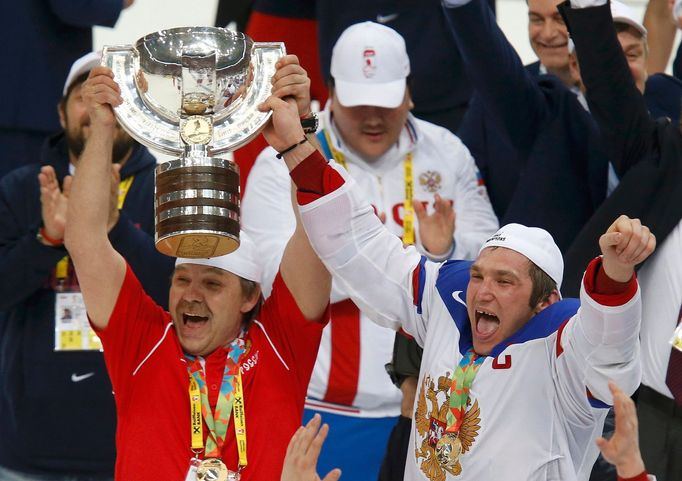 Russia's head coach Oleg Znarok (L) and Alexander Ovechkin celebrate with the trophy after winning their men's ice hockey World Championship final game against Finland at