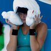 Eugenie Bouchard of Canada sits with an ice-packed towel over her head during a break in play in her women's singles match against Lauren Davis of the U.S. at the Australian Open 2014 tennis tournamen