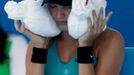 Eugenie Bouchard of Canada sits with an ice-packed towel over her head during a break in play in her women's singles match against Lauren Davis of the U.S. at the Austral