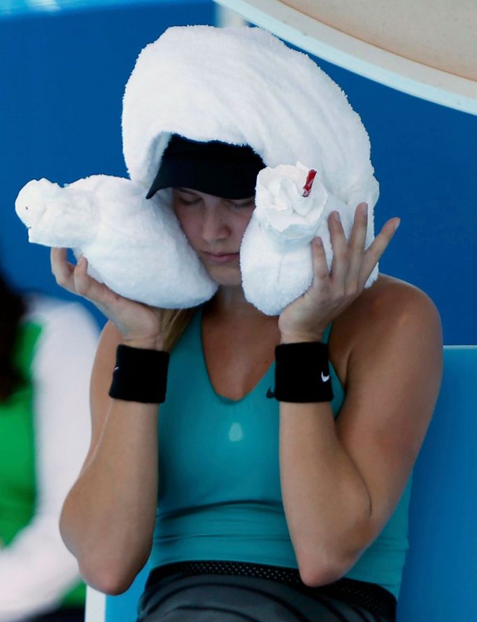 Eugenie Bouchard of Canada sits with an ice-packed towel over her head during a break in play in her women's singles match against Lauren Davis of the U.S. at the Austral