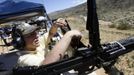 Lorin Kramer loads his M60 machine gun during the Big Sandy Shoot in Mohave County, Arizona March 22, 2013. The Big Sandy Shoot is the largest organized machine gun shoot in the United States attended by shooters from around the country. Vintage and replica style machine guns and cannons are some of the weapons displayed during the event. Picture taken March 22, 2013. REUTERS/Joshua Lott (UNITED STATES - Tags: SOCIETY) Published: Bře. 25, 2013, 3:34 odp.