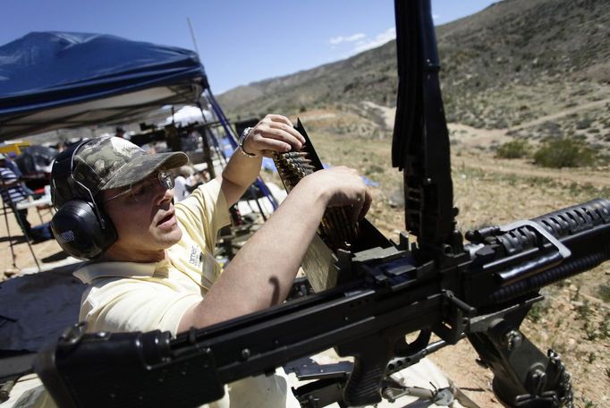 Lorin Kramer loads his M60 machine gun during the Big Sandy Shoot in Mohave County, Arizona March 22, 2013. The Big Sandy Shoot is the largest organized machine gun shoot in the United States attended by shooters from around the country. Vintage and replica style machine guns and cannons are some of the weapons displayed during the event. Picture taken March 22, 2013. REUTERS/Joshua Lott (UNITED STATES - Tags: SOCIETY) Published: Bře. 25, 2013, 3:34 odp.