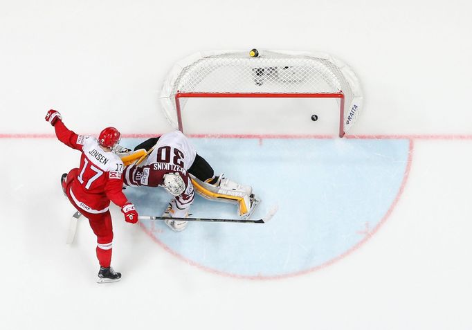 Denmark's Nicklas Jensen scores on his penalty shot against Latvia's goalkeeper Elvis Merzlikins.