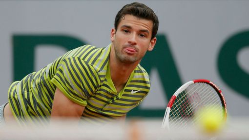 Grigor Dimitrov of Bulgaria eyes the ball during his men's singles match against Ivo Karlovic of Croatia at the French Open tennis tournament at the Roland Garros stadium