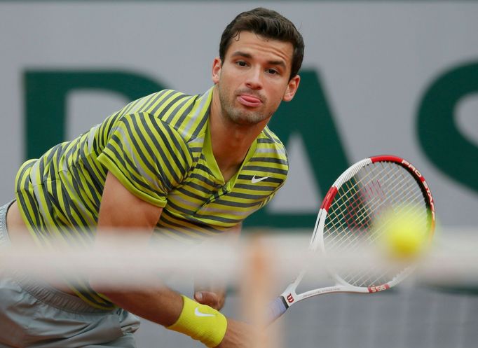 Grigor Dimitrov of Bulgaria eyes the ball during his men's singles match against Ivo Karlovic of Croatia at the French Open tennis tournament at the Roland Garros stadium