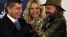 Circus owner Jaromir Joo (R) holds a tiger cub as he congratulates Andrej Babis (L), leader of the ANO movement