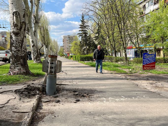 Muž prochází kolem rakety, která zapadla do jedné z silnic města Rubižně. Ruské jednotky podle americké CNN město ovládly.