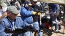 Shooters fire their weapons during the Big Sandy Shoot in Mohave County, Arizona March 23, 2013. The Big Sandy Shoot is the largest organized machine gun shoot in the United States attended by shooters from around the country. Vintage and replica style machine guns and cannons are some of the weapons displayed during the event. Picture taken March 22, 2013. REUTERS/Joshua Lott (UNITED STATES - Tags: SOCIETY) Published: Bře. 25, 2013, 3:35 odp.