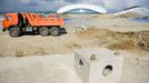 Olympic Park under construction in Sochi, Russia SOCHI, RUSSIA. MAY 20, 2013. A truch at the construction site of Olympic Park with Bolshoi Stadium in the distance. In 2014 Sochi is set to host 2014 Winter Olympic Games.