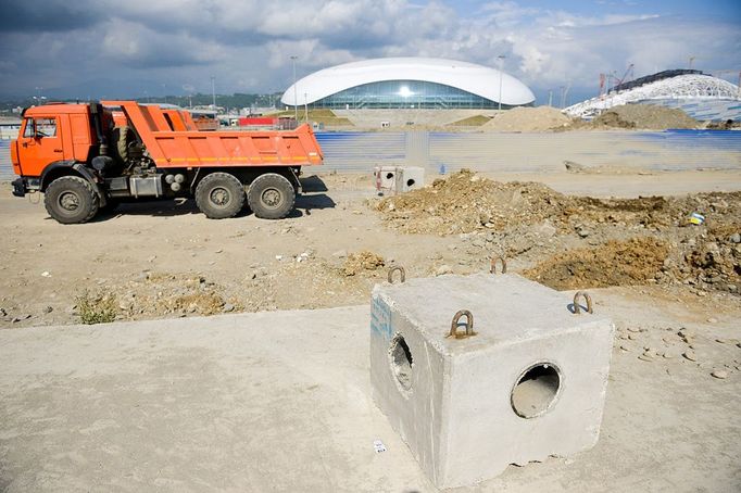 Olympic Park under construction in Sochi, Russia SOCHI, RUSSIA. MAY 20, 2013. A truch at the construction site of Olympic Park with Bolshoi Stadium in the distance. In 2014 Sochi is set to host 2014 Winter Olympic Games.