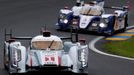 Andre Lotterer of Germany drives his Audi R18 E-Tron Quattro just ahead of the Toyota TS030 Hybrid car driven by France's Nicolas Lapierre during the Le Mans 24-hour spor