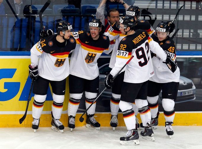 Germany's Thomas Oppenheimer (obscured) celebrates his goal against Switzerland with team mates during their men's ice hockey World Championship Group B game at Minsk Are