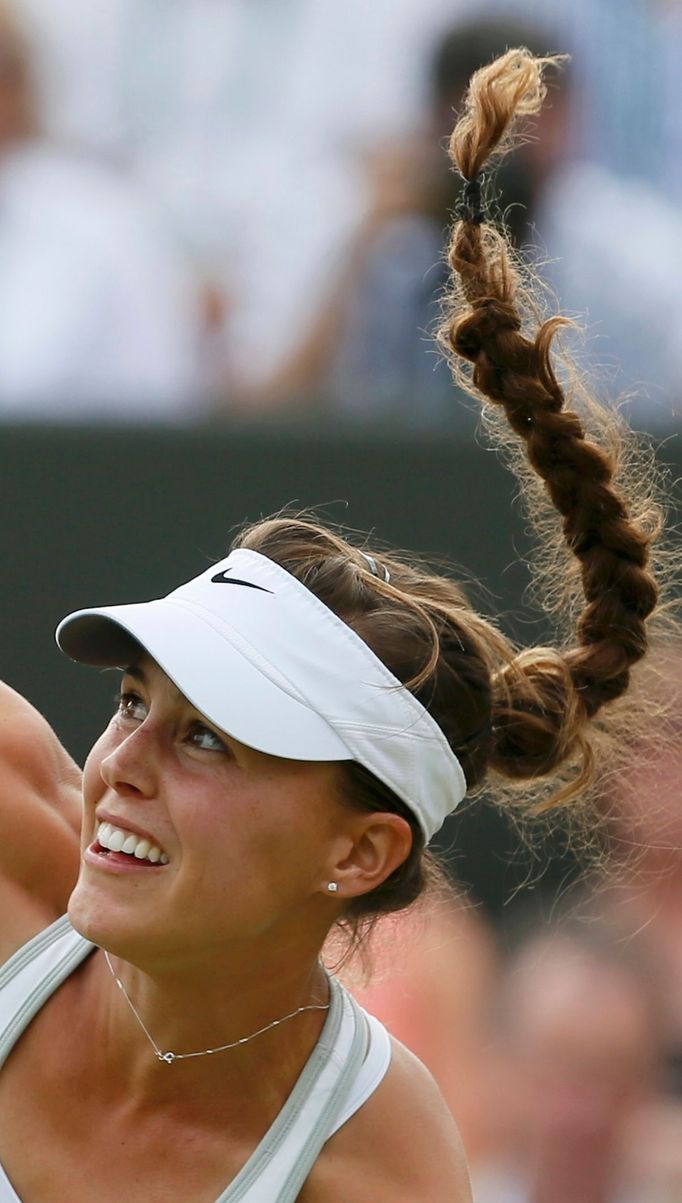 Michelle Larcher De Brito of Portugal serves to Maria Sharapova of Russia during their women's singles tennis match at the Wimbledon Tennis Championships, in London June