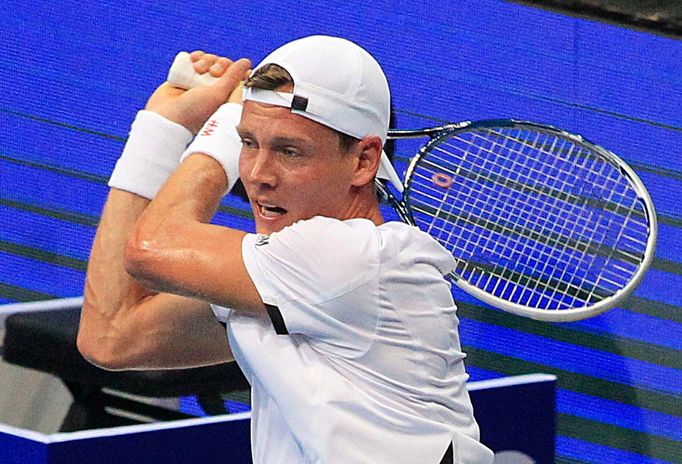 Tomas Berdych of the Singapore Slammers returns a shot to Marin Cilic of the UAE Royals during their men's singles match at the International Premier Tennis League in Man