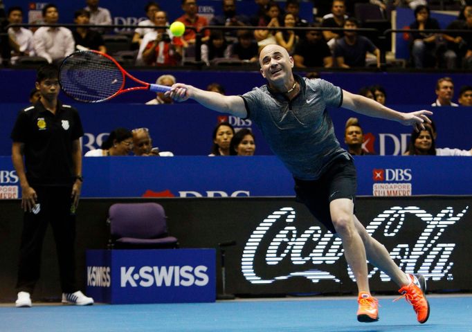 Singapore Slammers' Andre Agassi of the U.S. hits a return to Manila Mavericks' Mark Philippoussis of Australia during their men's singles match at the International Prem