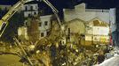 This picture taken on January 28, 2013 shows workers using machinery to fill in a sinkhole that buildings collapsed into near a subway construction site in Guangzhou, south China's Guangdong province. The hole measured about 1,000 square feet across and was around 30 feet deep, but no one was killed, according to a state media report. CHINA OUT AFP PHOTO