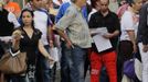 Luis Salgado (in red pants), nicknamed Chucho, holds his documents as he waits in line with other Cubans to apply for a visa at the U.S. Interests Section in Havana, January 31, 2013. Chucho's visa application, based on his father's status as legal resident in the U.S., was approved and he was reunited in Miami with his father, Jesus Salgado, who had escaped Cuba on a frail boat ten years earlier. The Salgados are among many Cubans taking advantage of Cuba's new travel policy in place since last January, which allows citizens to leave the country with just a passport and no need for much-hated exit visas required since 1961. Picture taken January 31, 2013. REUTERS/Desmond Boylan (CUBA - Tags: POLITICS SOCIETY) Published: Dub. 11, 2013, 12:50 odp.