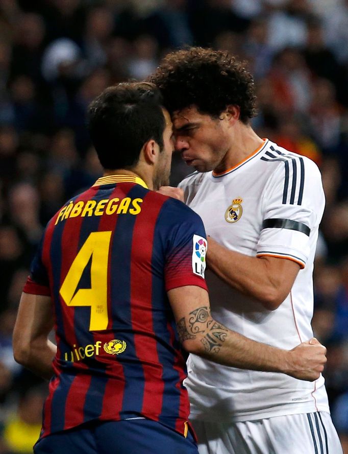 Real Madrid's Pepe touches the neck of Barcelona's Cesc Fabregas during La Liga's second 'Clasico' soccer match of the season in Madrid