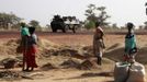 Malian women look at a French military vehicle drive past, as part of a convoy of French military vehicles including armored personnel carriers, jeeps and supply trucks, heading toward the recently liberated town of Diabaly January 24, 2013. REUTERS/Eric Gaillard (MALI - Tags: CIVIL UNREST CONFLICT MILITARY) Published: Led. 24, 2013, 5:30 odp.