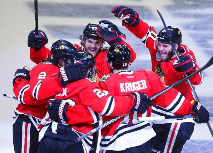 Chicago Blackhawks' Michael Frolik (67) and Brandon Saad (20) celebrate a goal by teammate Johnny Oduya (27) with Duncan Keith (L) and Marcus Kruger during the third peri