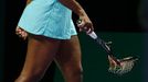 Serena Williams of the U.S. walks off the court with her second broken racquet during her WTA Finals singles semi-finals tennis match against Caroline Wozniacki of Denmar