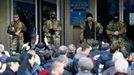 Pro-Russian armed men stand guard as pro-Russian supporters gather outside the mayor's office in Slaviansk April 14, 2014.