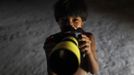 A Yawalapiti boy poses with a camera in the Xingu National Park, Mato Grosso State, May 8, 2012. In August the Yawalapiti tribe will hold the Quarup, which is a ritual held over several days to honour in death a person of great importance to them. This year the Quarup will be honouring two people - a Yawalapiti Indian who they consider a great leader, and Darcy Ribeiro, a well-known author, anthropologist and politician known for focusing on the relationship between native peoples and education in Brazil. Picture taken May 8, 2012. REUTERS/Ueslei Marcelino (BRAZIL - Tags: SOCIETY ENVIRONMENT) ATTENTION EDITORS - PICTURE 22 OF 28 FOR PACKAGE 'LIFE WITH THE YAWALAPITI TRIBE' Published: Kvě. 15, 2012, 5:11 odp.