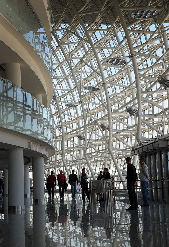 People walk inside the Bolshoi Ice Dome arena - ice hockey venue at the Olympic Park in Adler outside Sochi, during the IIHF U18 International Ice Hockey World Championship on April 28, 2013.