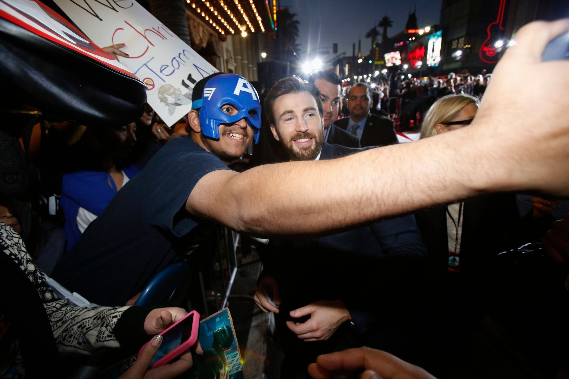 Cast member Evans poses with a fan at the premiere of &quot;Captain America: The Winter Soldier&quot; in Hollywood