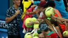 Kokkinakis of Australia signs autographs for fans following his first round victory over Benneteau of France at the Brisbane International tennis tournament in Brisbane