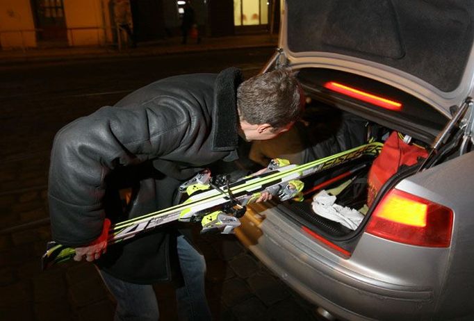 Po několika minutách přijelo stříbrné audi. Pitr ještě fotografům ukázal, že opravdu jede rovnou z dovolené. S lyžemi v kufru.