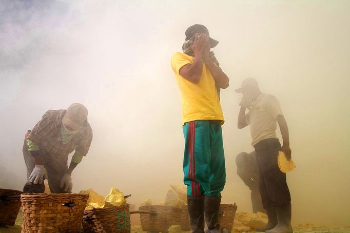 Sulfur miners risk health on Mount Ijen Jakarta, Indonesia. 24th October 2012 -- Miners cover their nose and eyes to avoid smoke that can cause tightness and pain in the