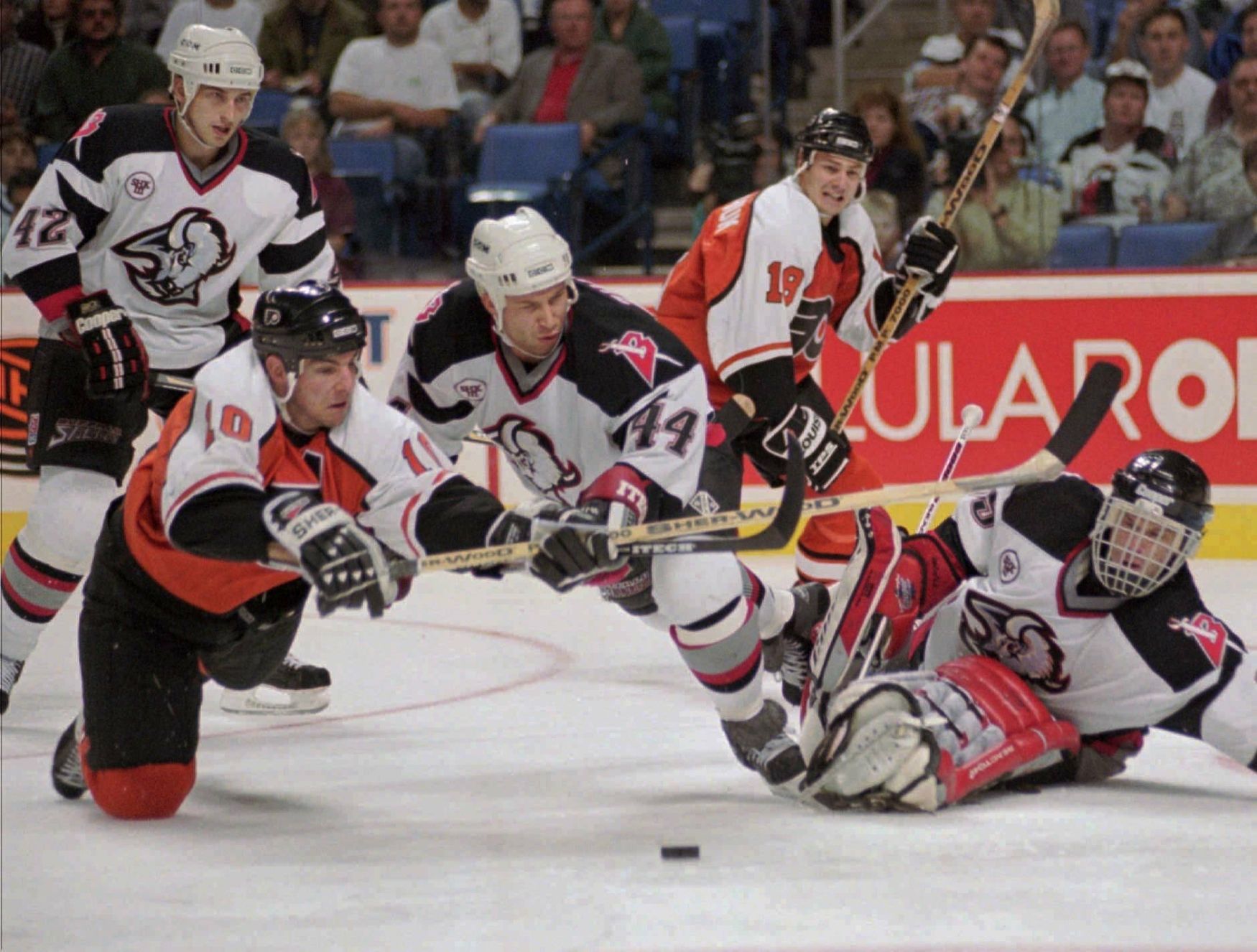 NHL Buffalo Sabres defenseman Alexei Zhitnik (44) flies to defend against Philadelphia Flyers left wing John LeClair, left, as goalie Dominik Hasek, right, covers the net in the third period