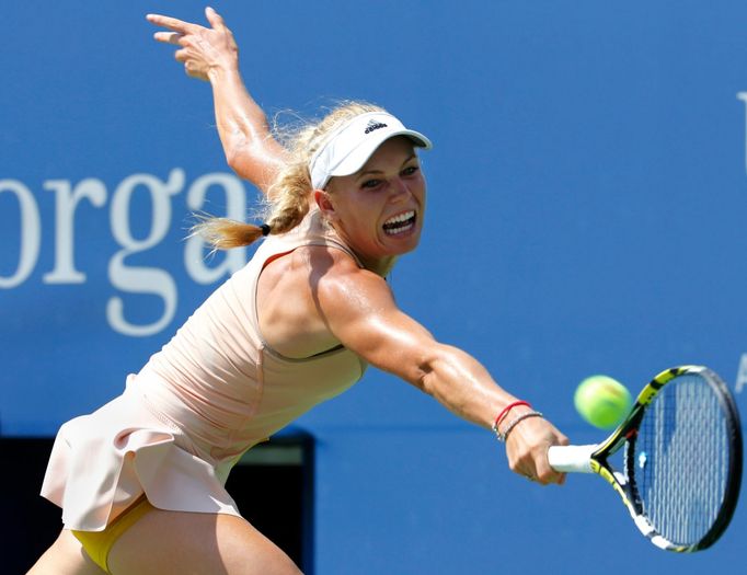 Caroline Wozniacki of Denmark hits a return to Maria Sharpova of Russia during their match at the 2014 U.S. Open tennis tournament in New York