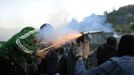 Coal miners fire a rocket during a clash with Spanish national riot police in the surroundings of the "El Soton" coal mine in El Entrego, near Oviedo, northern Spain June 15, 2012. The miners were protesting against the government's proposal to decrease funding for coal production. REUTERS/Eloy Alonso (SPAIN - Tags: CIVIL UNREST BUSINESS EMPLOYMENT ENERGY) Published: Čer. 15, 2012, 11:41 dop.